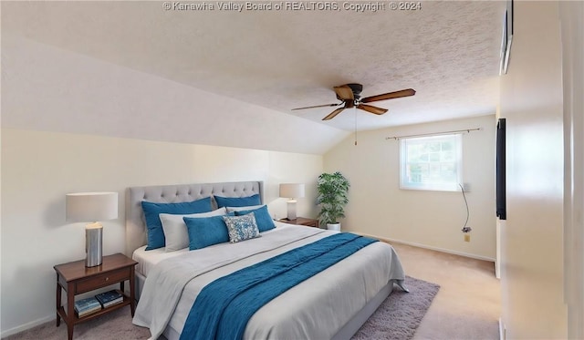 bedroom featuring a textured ceiling, light colored carpet, vaulted ceiling, and ceiling fan