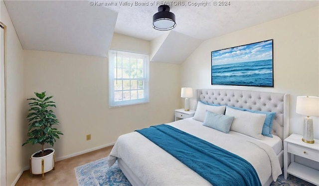 carpeted bedroom featuring vaulted ceiling