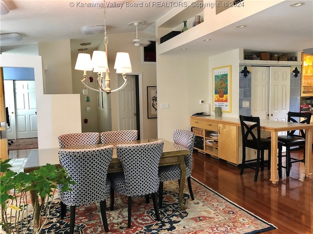 dining area with an inviting chandelier and hardwood / wood-style floors