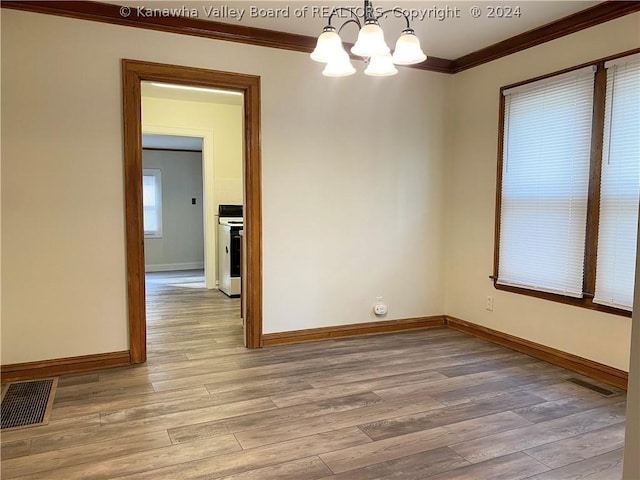 empty room featuring light wood-type flooring, ornamental molding, and a notable chandelier