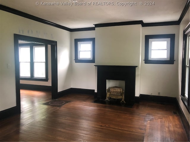 unfurnished living room featuring wood-type flooring and ornamental molding