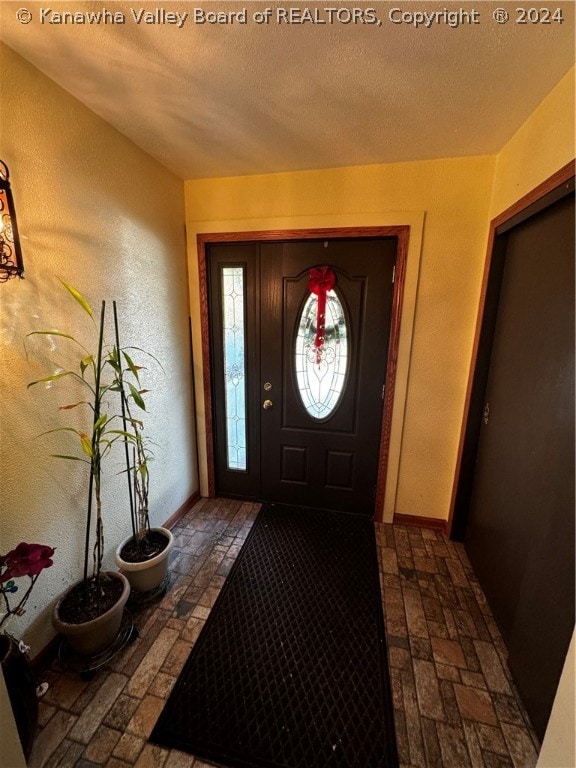 entryway with a textured ceiling