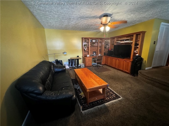 living room with ceiling fan, carpet, built in features, and a textured ceiling