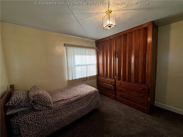 carpeted bedroom with a textured ceiling