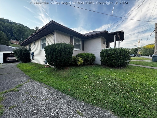 view of side of property with a yard