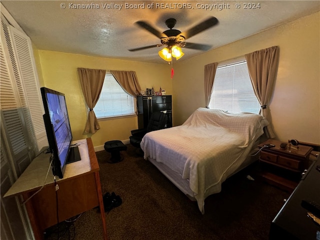 bedroom featuring a closet, carpet flooring, a textured ceiling, and ceiling fan