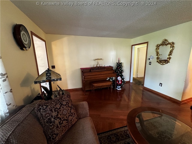 living room with a textured ceiling and parquet floors