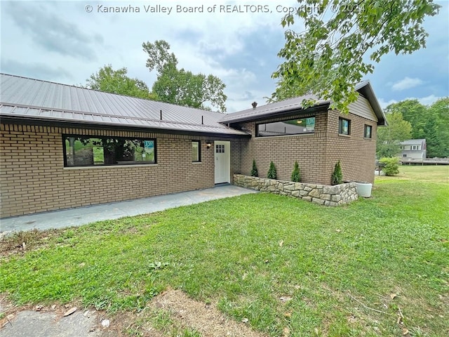 rear view of house featuring a lawn