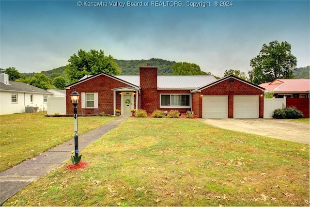 single story home featuring a garage and a front lawn