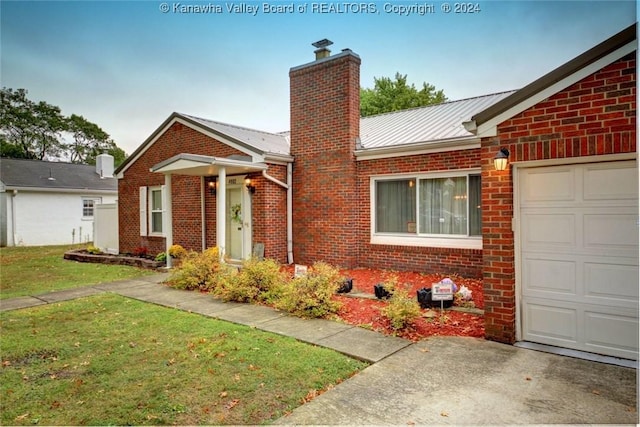 view of front of home with a garage and a front yard