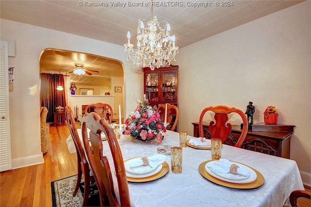 dining area featuring crown molding, ceiling fan with notable chandelier, and light hardwood / wood-style floors