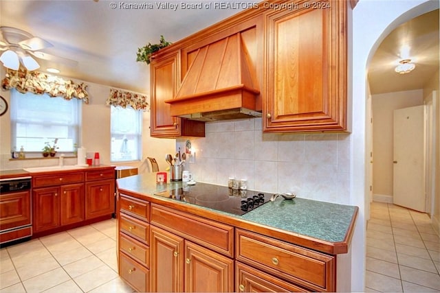 kitchen with dishwashing machine, light tile patterned floors, tasteful backsplash, black electric cooktop, and custom exhaust hood