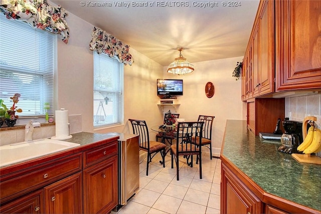 dining room featuring light tile patterned flooring, sink, and a chandelier