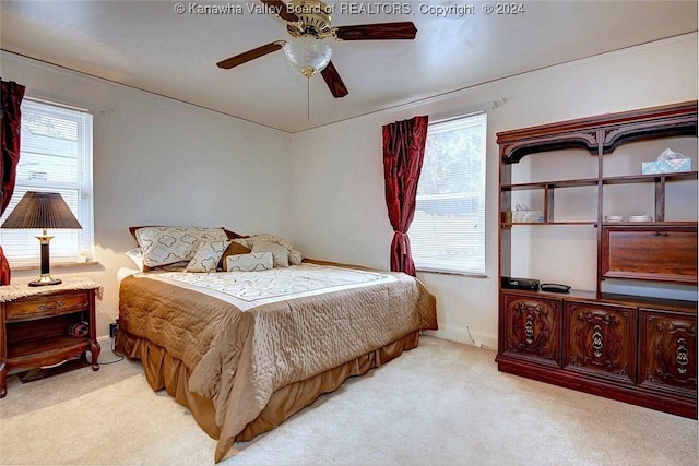 bedroom featuring light carpet and ceiling fan