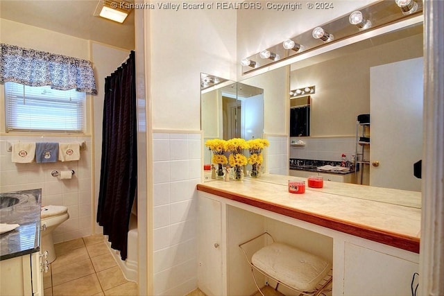 bathroom with tile patterned flooring, vanity, tile walls, and shower / bath combo with shower curtain