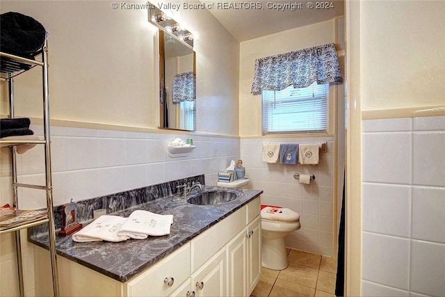 bathroom featuring tile patterned flooring, vanity, tile walls, and toilet