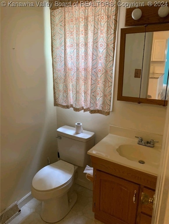 bathroom with tile patterned floors, toilet, and vanity