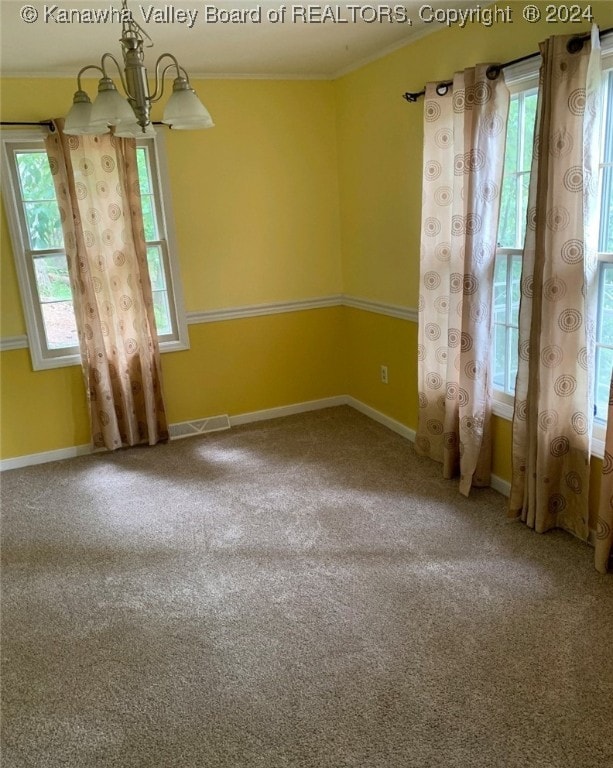 unfurnished room featuring carpet flooring and a notable chandelier