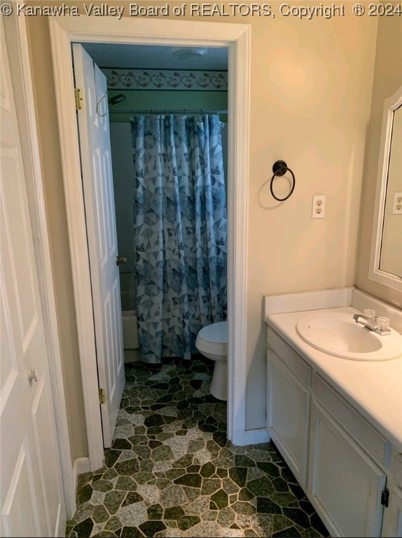 full bathroom featuring shower / bath combo with shower curtain, vanity, tile patterned floors, and toilet