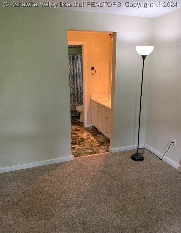 interior space featuring tile patterned flooring, toilet, and vanity