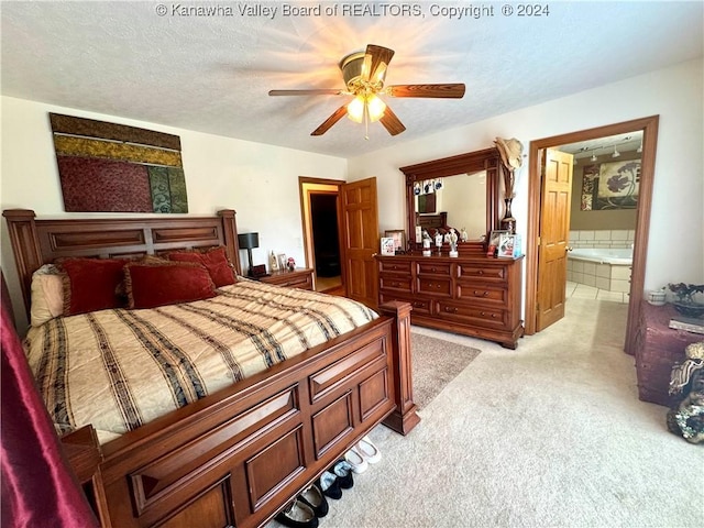 bedroom featuring ceiling fan, connected bathroom, light colored carpet, and a textured ceiling