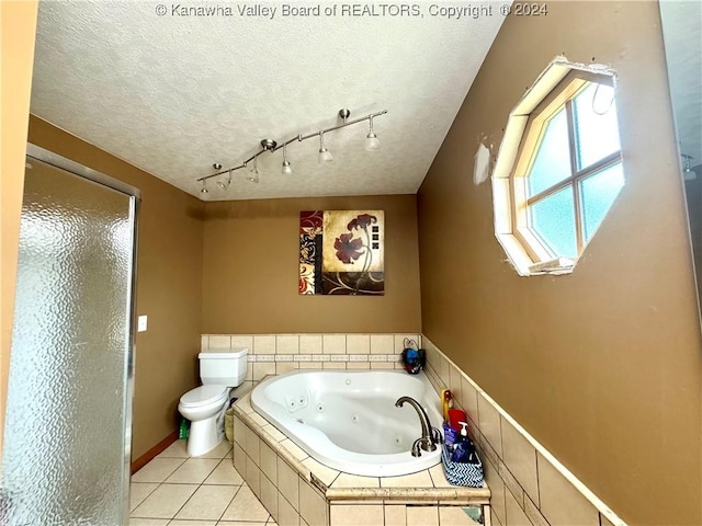 bathroom with tile patterned flooring, independent shower and bath, toilet, and a textured ceiling