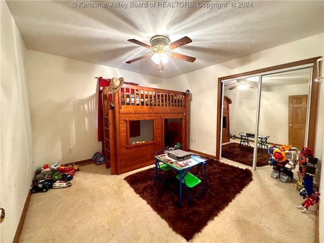 bedroom featuring carpet flooring, a textured ceiling, and ceiling fan