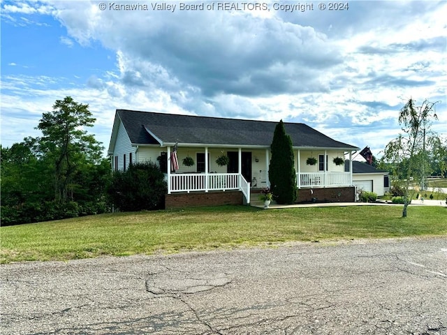 view of front of house with a garage, covered porch, and a front yard