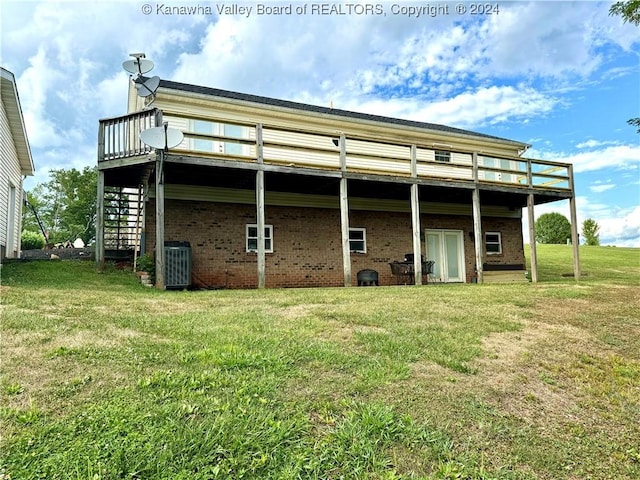 view of outbuilding with a yard and central air condition unit