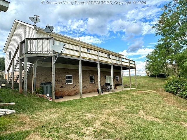 back of property featuring a wooden deck, a yard, a patio area, and central air condition unit