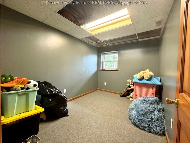 rec room featuring a drop ceiling and carpet