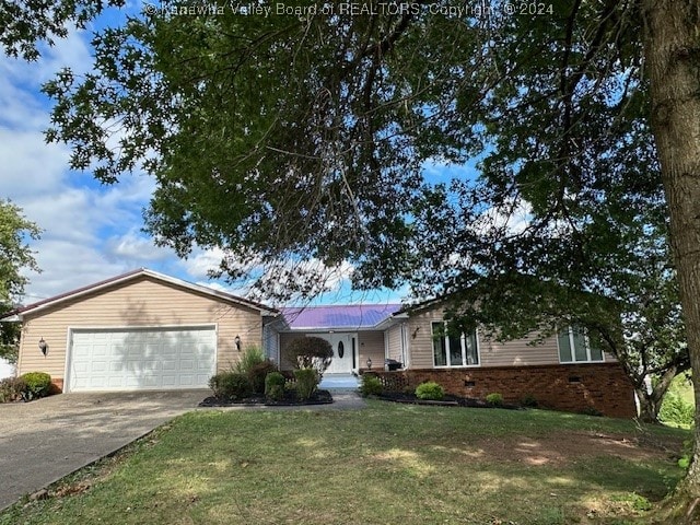 ranch-style home with a garage and a front lawn