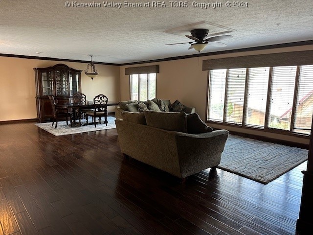 living room with ceiling fan, crown molding, dark hardwood / wood-style flooring, and a textured ceiling