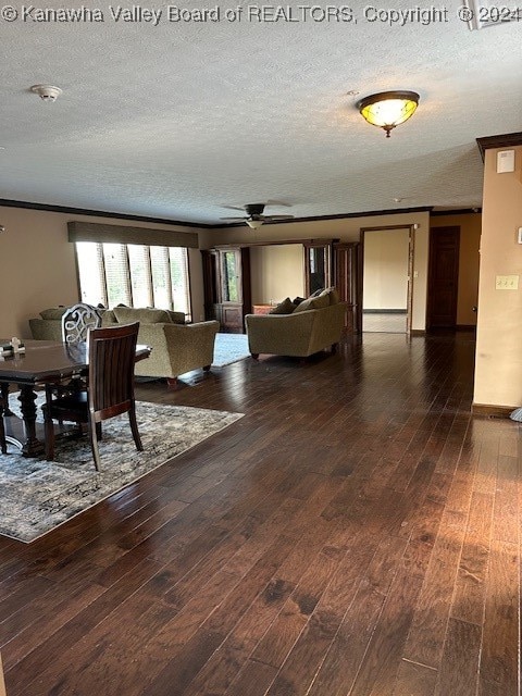 dining space with ornamental molding, a textured ceiling, and hardwood / wood-style floors