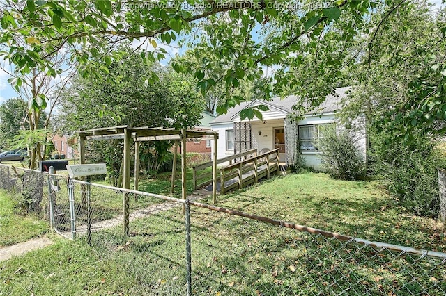 view of front of house with a gate, fence, and a front lawn