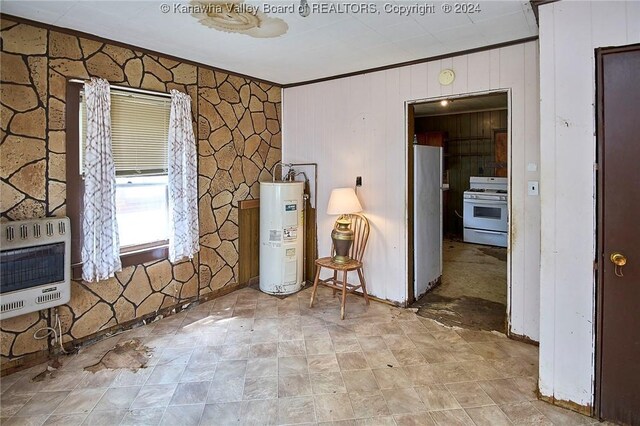 interior space with water heater, tile patterned floors, and stainless steel fridge