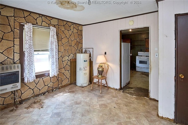 unfurnished room featuring crown molding, electric water heater, and heating unit