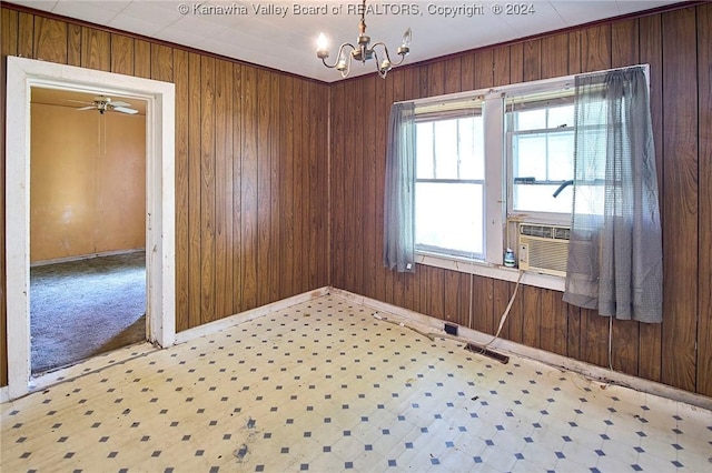 unfurnished room with cooling unit, an inviting chandelier, tile patterned floors, and wooden walls