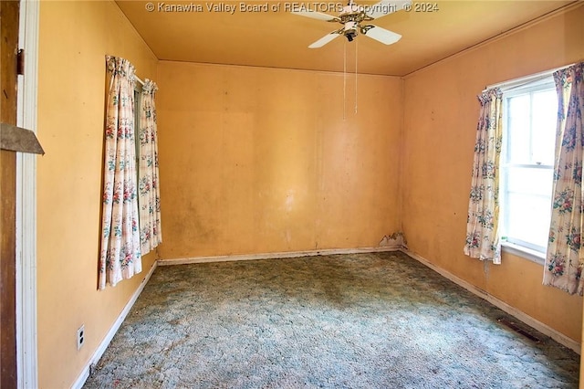 spare room featuring carpet floors, baseboards, and a ceiling fan