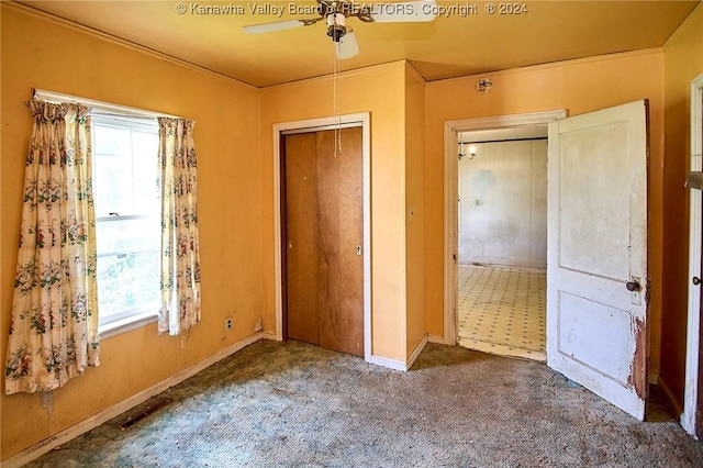 unfurnished bedroom with carpet floors, visible vents, baseboards, and a ceiling fan