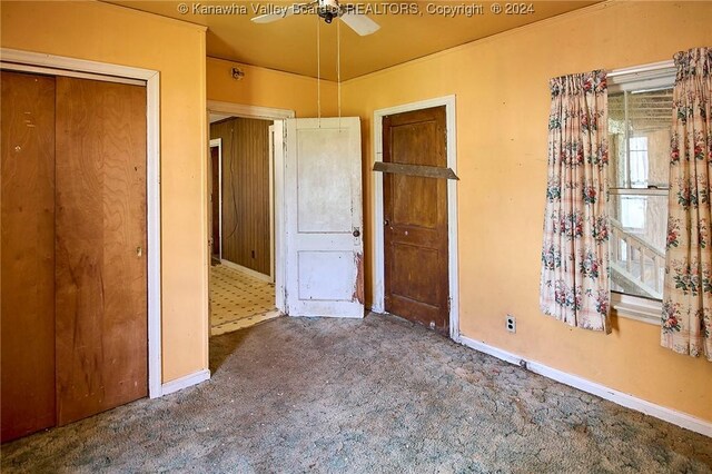 unfurnished bedroom with ceiling fan, a closet, and carpet floors