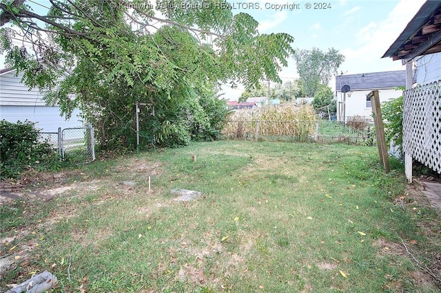 view of yard with a garage and fence