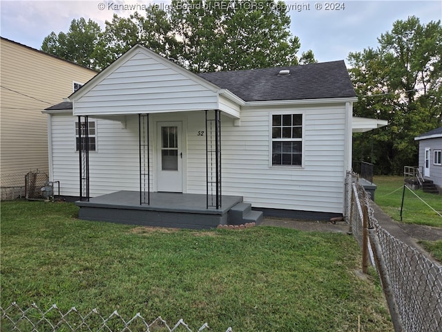 back of house with a lawn