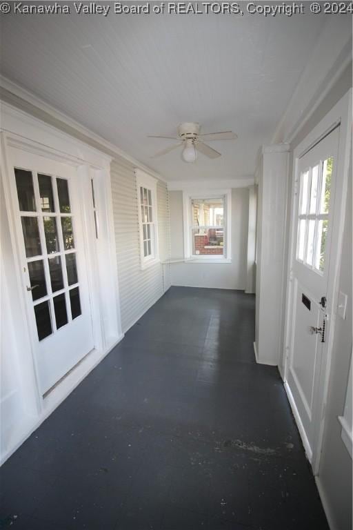 unfurnished sunroom with ceiling fan