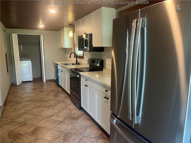 kitchen with white cabinets, washer / dryer, backsplash, stainless steel appliances, and sink