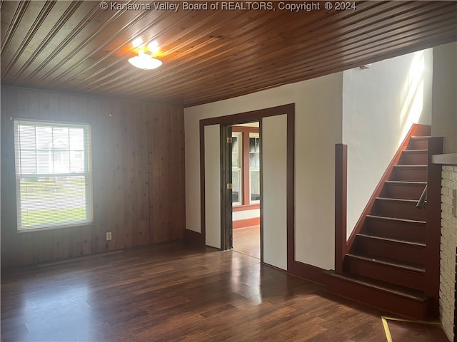 spare room with wood ceiling, wooden walls, and hardwood / wood-style floors