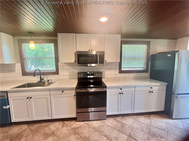 kitchen featuring sink, stainless steel appliances, light tile patterned floors, and wood ceiling