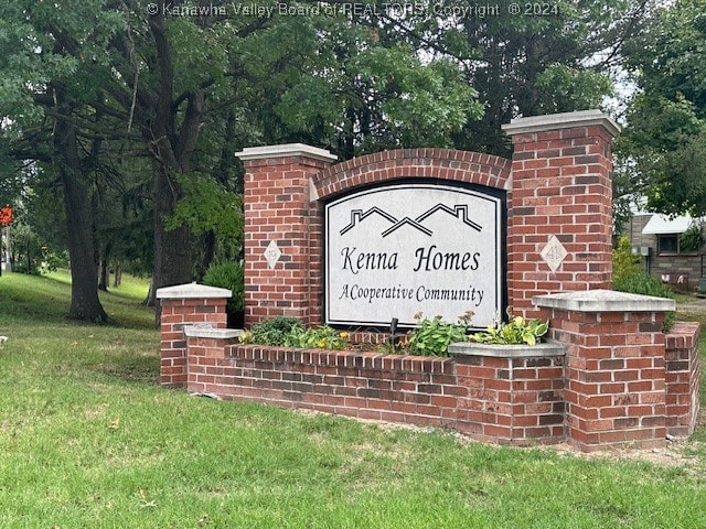 community / neighborhood sign with a yard