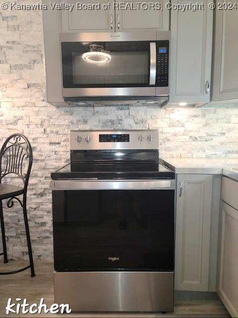 kitchen featuring appliances with stainless steel finishes and wood-type flooring