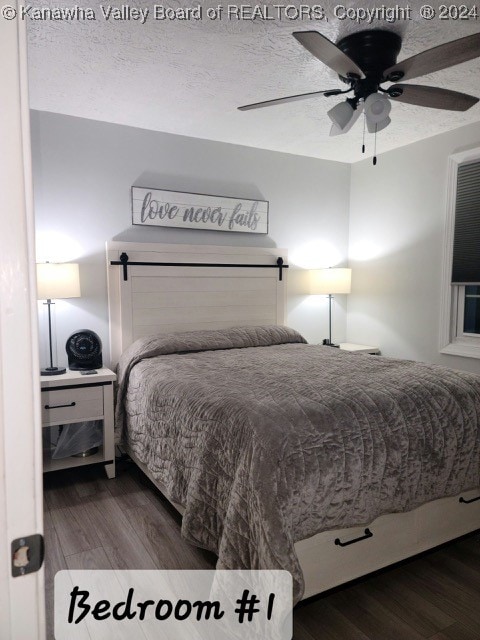 bedroom with ceiling fan, hardwood / wood-style flooring, and a textured ceiling